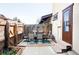 Well maintained backyard deck with chairs and a table, with a wooden fence and flower boxes at 3820 S Fraser St, Aurora, CO 80014