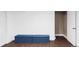 Basement rec room area with hardwood floors and blue ottoman benches by a closet space at 3820 S Fraser St, Aurora, CO 80014