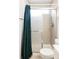 Bathroom with a glass-doored shower, shower curtain, and a clean, tiled design at 3820 S Fraser St, Aurora, CO 80014