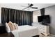 Bedroom features a ceiling fan, a tv, black out curtains, and a white dresser at 3820 S Fraser St, Aurora, CO 80014