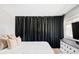 Bedroom features a ceiling fan, a tv, black out curtains, and a white dresser at 3820 S Fraser St, Aurora, CO 80014