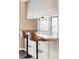 Kitchen bar with two leather stools and decorative pendant lighting at 3820 S Fraser St, Aurora, CO 80014