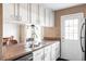 Open kitchen layout featuring white cabinets and view into dining area at 3820 S Fraser St, Aurora, CO 80014