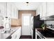 Functional kitchen with white cabinets, laminate countertops, and modern appliances at 3820 S Fraser St, Aurora, CO 80014