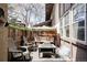Charming outdoor patio space with cushioned swing, chairs, table, and covered patio area at 3820 S Fraser St, Aurora, CO 80014