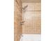 Shower showcasing decorative tile work and showerhead at 3820 S Fraser St, Aurora, CO 80014