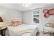 Cozy bedroom with a cushioned headboard, decorative pillows, and natural light from the window at 4142 Chase St, Denver, CO 80212
