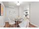 Bright dining area with a glass table, comfortable chairs, and a view into the modern kitchen at 4142 Chase St, Denver, CO 80212