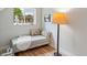 Cozy reading nook with a plush bench, decorative pillows and a stylish floor lamp at 4142 Chase St, Denver, CO 80212