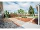 A charming backyard features decorative rock, mulch, and stepping stones at 5108 S Pennsylvania St, Littleton, CO 80121