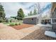 Backyard features a detached garage with a patio and a combination of decorative rocks and mulch at 5108 S Pennsylvania St, Littleton, CO 80121