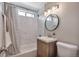 Updated bathroom featuring tiled shower, modern vanity, and neutral color palette at 5108 S Pennsylvania St, Littleton, CO 80121