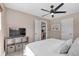 Comfortable bedroom featuring a ceiling fan, natural light, and a glimpse into the kitchen at 5108 S Pennsylvania St, Littleton, CO 80121