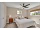 Cozy bedroom with a ceiling fan, plush bedding, and natural light from two windows at 5108 S Pennsylvania St, Littleton, CO 80121