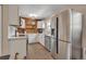 Modern kitchen with stainless steel appliances, white cabinetry, and wood accents at 5108 S Pennsylvania St, Littleton, CO 80121