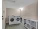 Spacious laundry room featuring a side-by-side washer and dryer with extra storage at 5108 S Pennsylvania St, Littleton, CO 80121