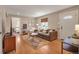 Inviting living room with hardwood floors, a gray couch, and an abundance of natural light at 5108 S Pennsylvania St, Littleton, CO 80121