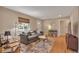 Comfortable living room featuring a couch, neutral colors, and hardwood flooring at 5108 S Pennsylvania St, Littleton, CO 80121