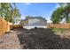 The backyard shows the home's grey siding and the gravel area at 811 Plum N Ave, Lochbuie, CO 80603