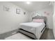 A charming bedroom is decorated with unique wall art, plush carpet, and a queen bed at 811 Plum N Ave, Lochbuie, CO 80603