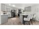 The kitchen boasts updated stainless appliances and a breakfast bar at 811 Plum N Ave, Lochbuie, CO 80603