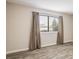 Bedroom featuring new floors, neutral walls, and a bright window at 8770 Corona St # 101, Denver, CO 80229