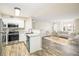 Bright kitchen features stainless steel appliances and granite countertops, flowing into a staged living area at 8770 Corona St # 101, Denver, CO 80229