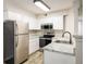 Updated kitchen with stainless steel appliances, granite countertops, and new flooring at 8770 Corona St # 101, Denver, CO 80229