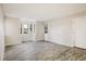 Spacious living room featuring hardwood floors and ample natural light from three windows at 8770 Corona St # 101, Denver, CO 80229
