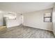 Open-concept living room with hardwood floors next to the kitchen at 8770 Corona St # 101, Denver, CO 80229