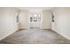 Open-concept living room with light-colored floors and large windows offering plenty of natural light at 8770 Corona St # 101, Denver, CO 80229