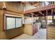 Private patio with an ornate decorative window, a door, and a gate at 8770 Corona St # 101, Denver, CO 80229
