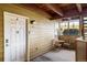 Private patio with a white door, small table and chairs, and a decorative window at 8770 Corona St # 101, Denver, CO 80229
