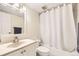 Bathroom featuring vanity with mirror and a shower/tub combo with a white curtain at 2160 S Vaughn Way # 104C, Aurora, CO 80014