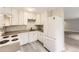 Modern kitchen featuring white cabinets, sleek countertops, and stainless steel appliances at 2160 S Vaughn Way # 104C, Aurora, CO 80014