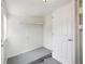Clean, unfinished basement space with painted walls, overhead lighting, and a door leading to another part of the house at 1301 Kenton St, Aurora, CO 80010