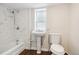 Bathroom with a combined shower and tub, pedestal sink, and toilet at 1301 Kenton St, Aurora, CO 80010