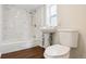 Bathroom features a tub with tiled walls, toilet and sink at 1301 Kenton St, Aurora, CO 80010