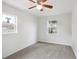 Bedroom featuring gray carpet, ceiling fan, and natural light at 1301 Kenton St, Aurora, CO 80010