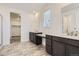 A spacious bathroom with a double vanity, and decorative mirrors at 576 Nightsky St, Erie, CO 80516