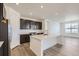 A modern kitchen is showcased with an island, stainless steel appliances, and sleek white countertops at 576 Nightsky St, Erie, CO 80516