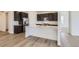 A modern kitchen is showcased with an island, stainless steel appliances, and sleek white countertops at 576 Nightsky St, Erie, CO 80516