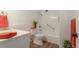 Cozy bathroom featuring a shower-tub combo and tiled walls, providing a clean and functional space at 625 S Alton Way # 3A, Denver, CO 80247