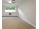 Inviting bedroom with large window, soft carpet, neutral color palette, and a ceiling fan for added comfort at 625 S Alton Way # 3A, Denver, CO 80247