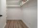 Organized walk-in closet with white walls and wooden floors is spacious and has plenty of storage at 625 S Alton Way # 3A, Denver, CO 80247