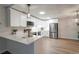 Bright kitchen features modern, stainless steel appliances and quartz countertops with a decorative pendant light at 625 S Alton Way # 3A, Denver, CO 80247