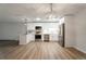 A spacious kitchen features stainless appliances, white cabinets, and a large island, all illuminated by modern lighting at 625 S Alton Way # 3A, Denver, CO 80247