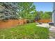 Backyard features a well-maintained lawn, garden decor, and a fire pit at 5362 S Danube Ct, Centennial, CO 80015