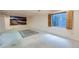 Unfinished basement featuring a window with wood shutters and neutral carpeting at 5362 S Danube Ct, Centennial, CO 80015