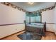 Cozy bedroom with a patterned rug, a metal bed frame and a window at 5362 S Danube Ct, Centennial, CO 80015